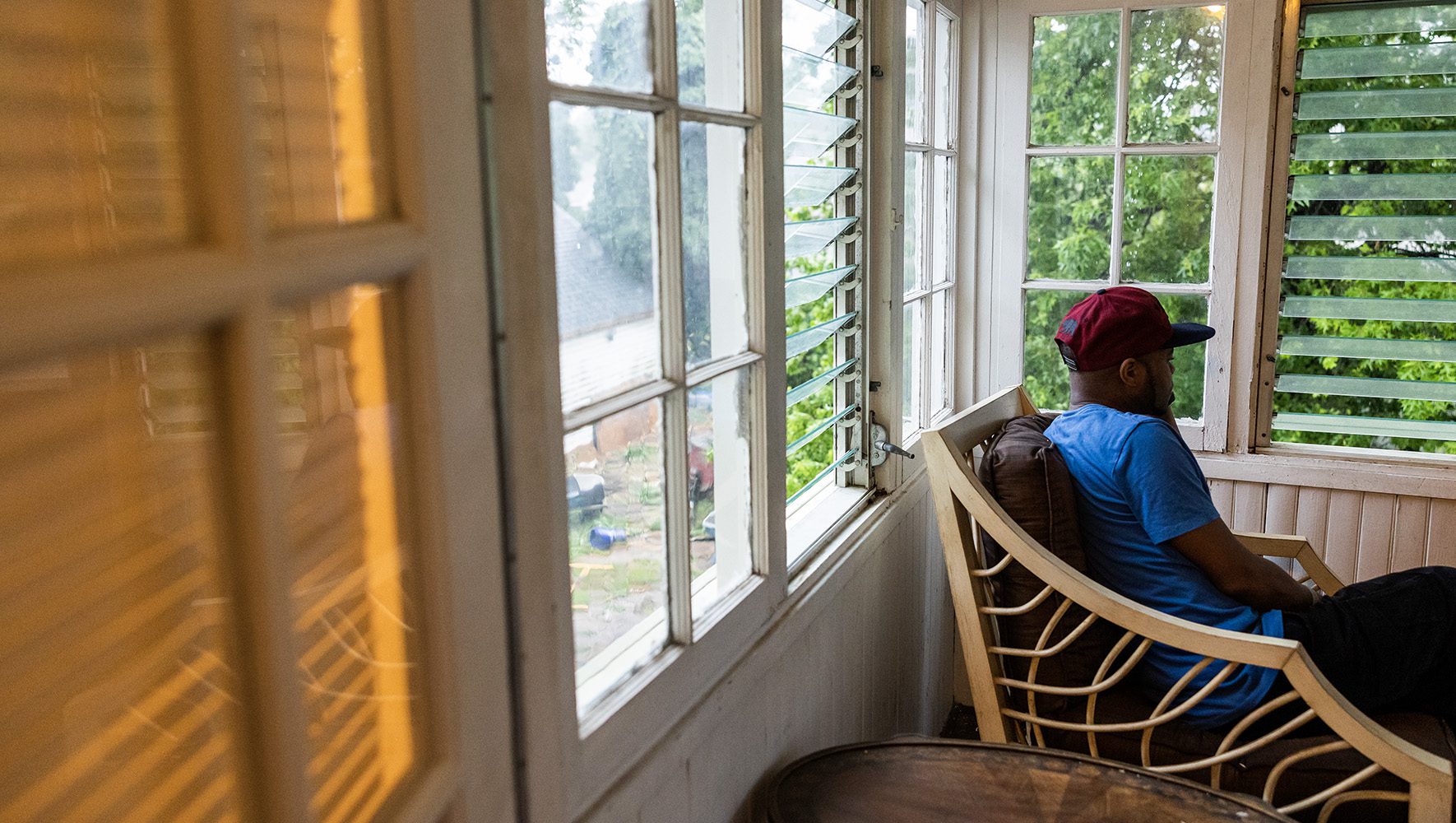 Robert, a gay Ugandan former refugee resettled by HIAS Pennsylvania, sits in his home near Philadelphia, Pennsylvania on June 12, 2023. | 