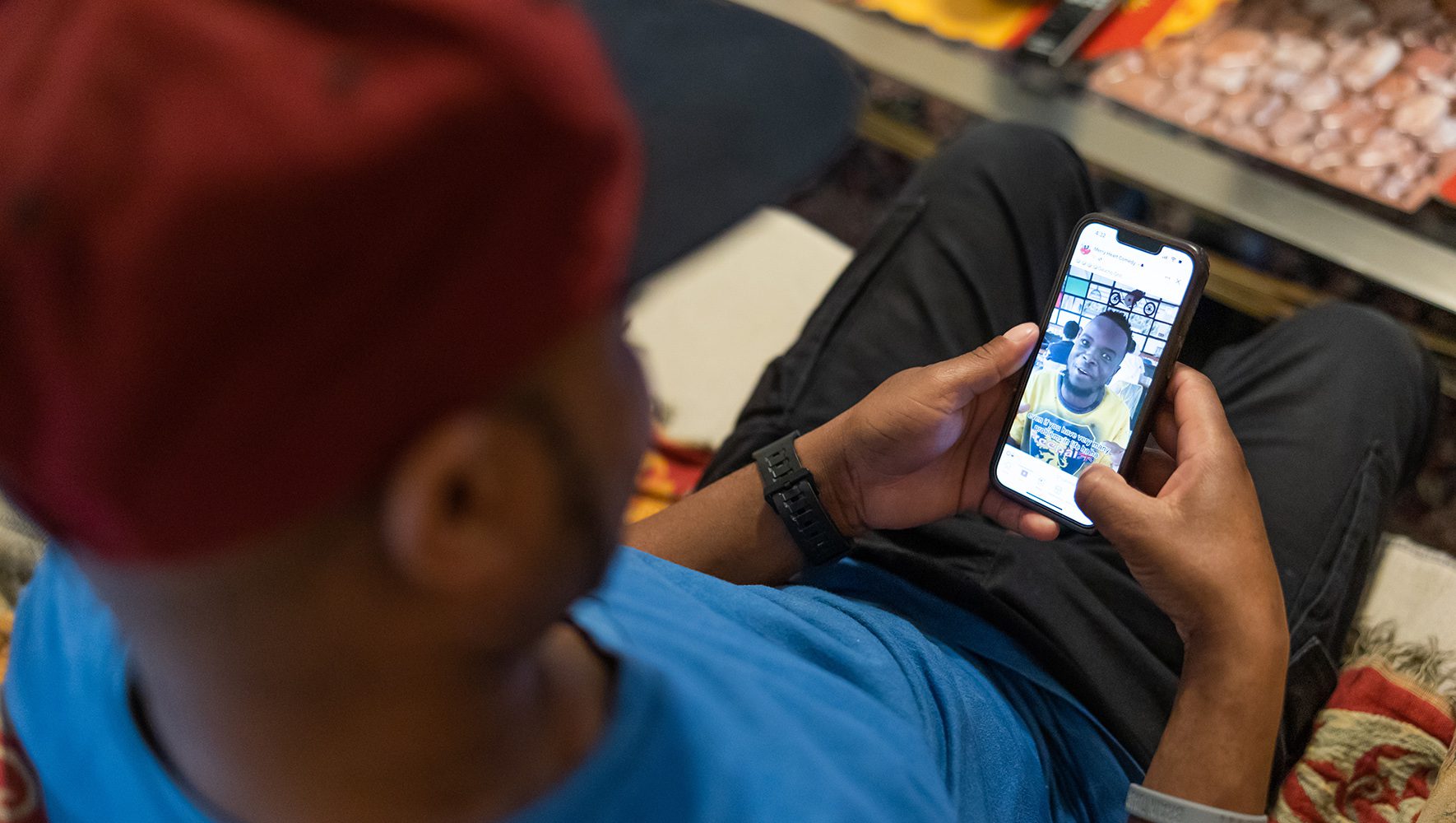 Robert watches a video discussing the recent anti-LGBTQ law passed in Uganda on his cell phone at his home near Philadelphia on June 12, 2023. | 