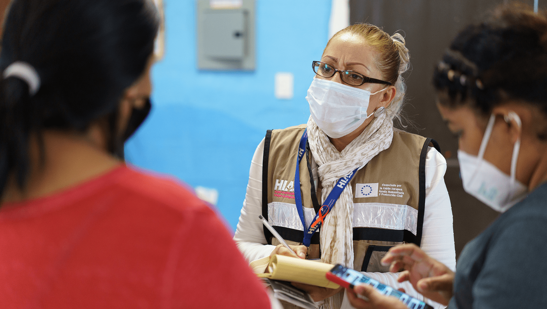 Social worker Carolina Hernandez gathers contact information of women who attended a workshop at Pan de Vida Migrant Shelter in Ciudad Juárez, Mexico. December 9, 2021. (Paul Ratje for HIAS)