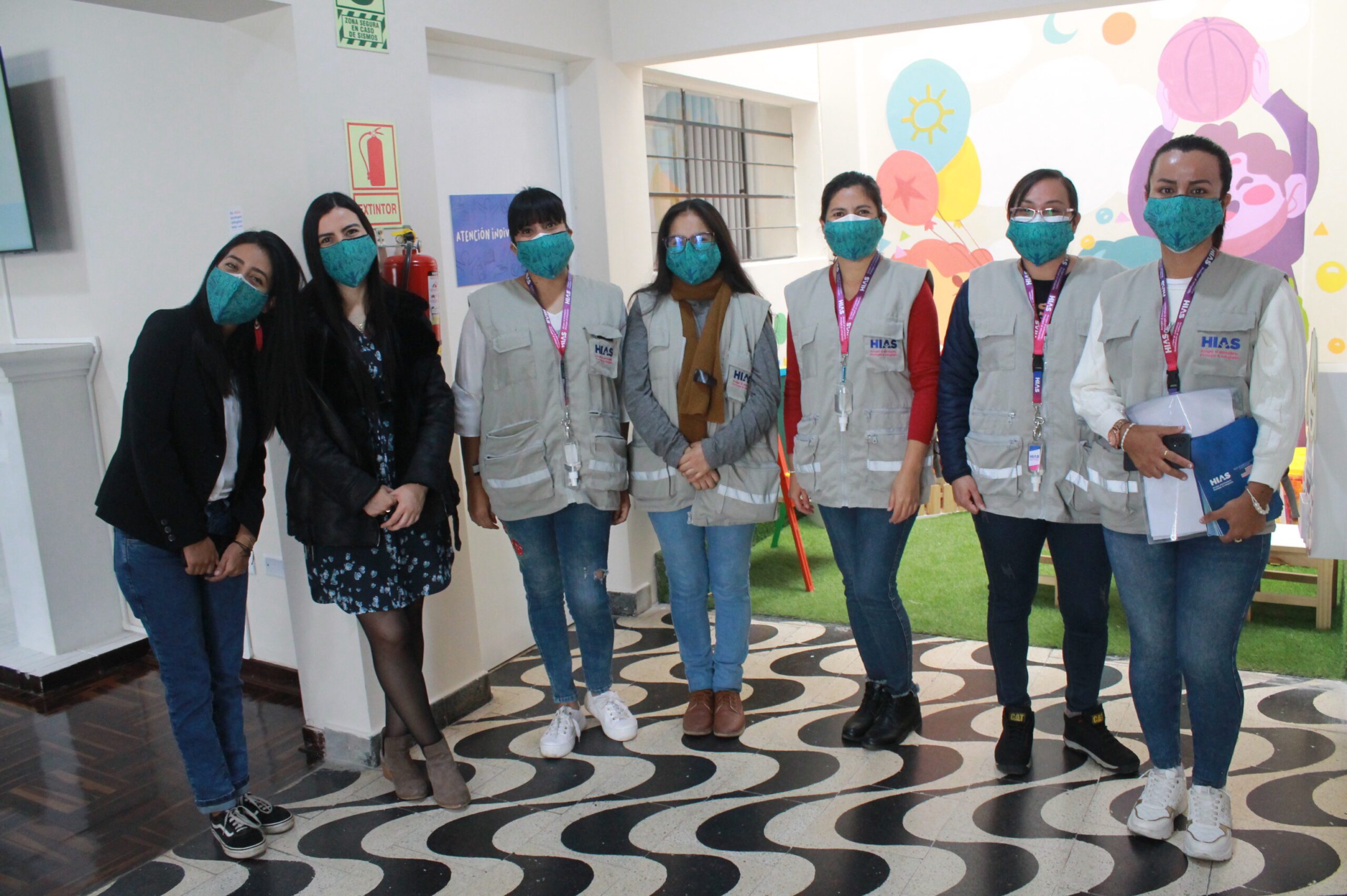 HIAS workers wearing masks stand in the new Trujillo office in Peru.