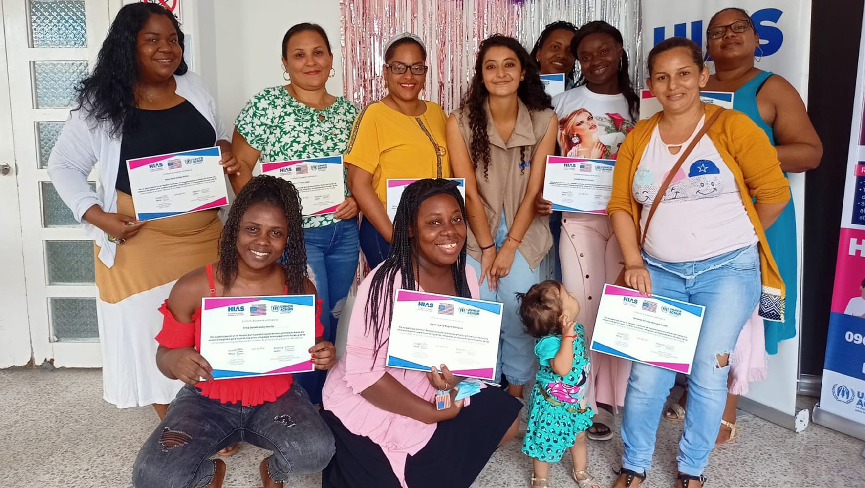 Participants in HIAS Ecuador's empowerment and protection curriculum for women and girls pose with their certificates of completion. | Congregational Philanthropy | Give to Refugees as a Community | HIAS