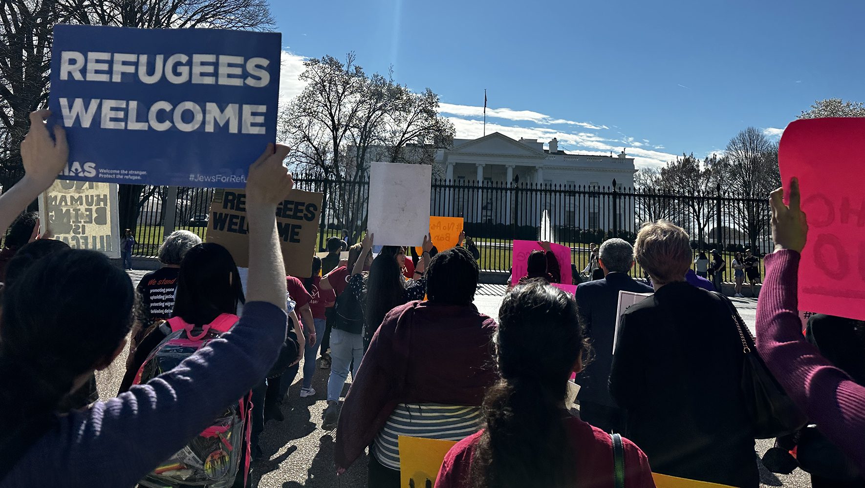 Activists protest a proposed rule that would limit access to asylum at the U.S.-Mexico border at a rally organized by Welcome With Dignity at the White House on February 23, 2023. (Jill Bussey/LIRS)