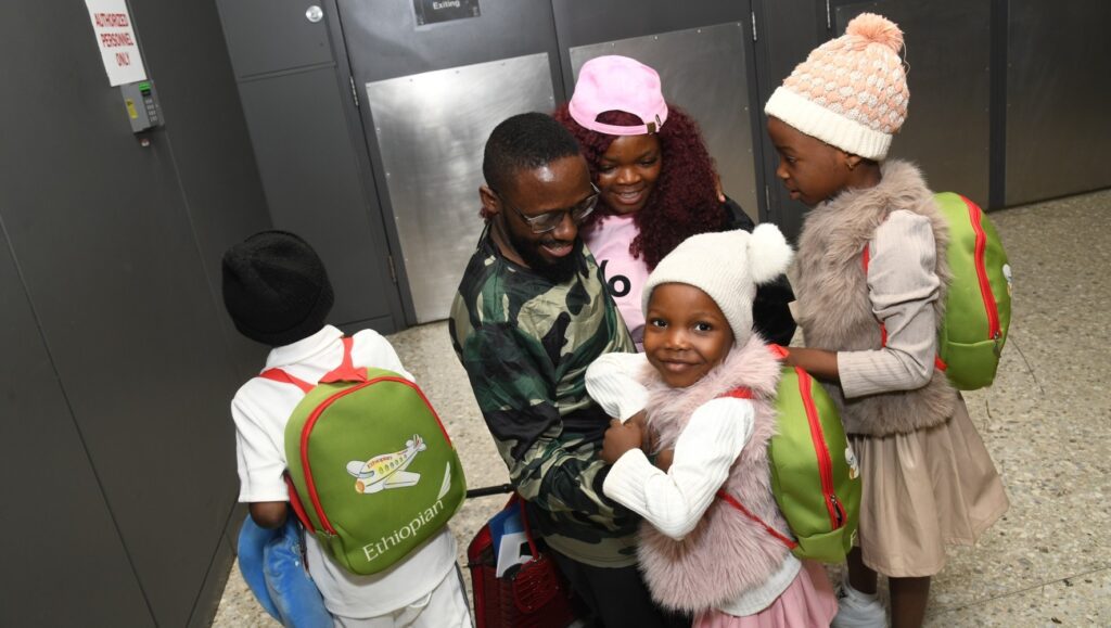 Fon, an asylee from Cameroon, reunites with his family in Washington, D.C. on December 5, 2025. HIAS provided Fon with legal and social services and helped him reunite with his wife and children. (HIAS)