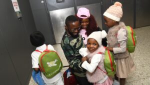Fon, an asylee from Cameroon, reunites with his family in Washington, D.C. on December 5, 2025. HIAS provided Fon with legal and social services and helped him reunite with his wife and children. (HIAS)