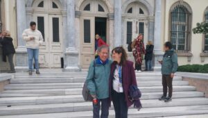 HIAS Greece client Pieter Wittenberg and Staff Attorney Maria Spiliotakara pose outside the courthouse in Lesvos during the proceedings of their case on January 15, 2026. Pieter and 23 other humanitarians were charged with human smuggling in 2018 for providing humanitarian assistance to asylum seekers in Greece. After eight years, they were acquitted on all charges. (HIAS Greece)