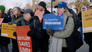 HIAS supporters join interfaith organizations as they gather for a rally during the Supreme Court hearing of Al Otro Lado v. Noem, in which HIAS has filed an amicus brief on March 24, 2026 in Washington, D.C. (Lindsay Kagalis/HIAS)