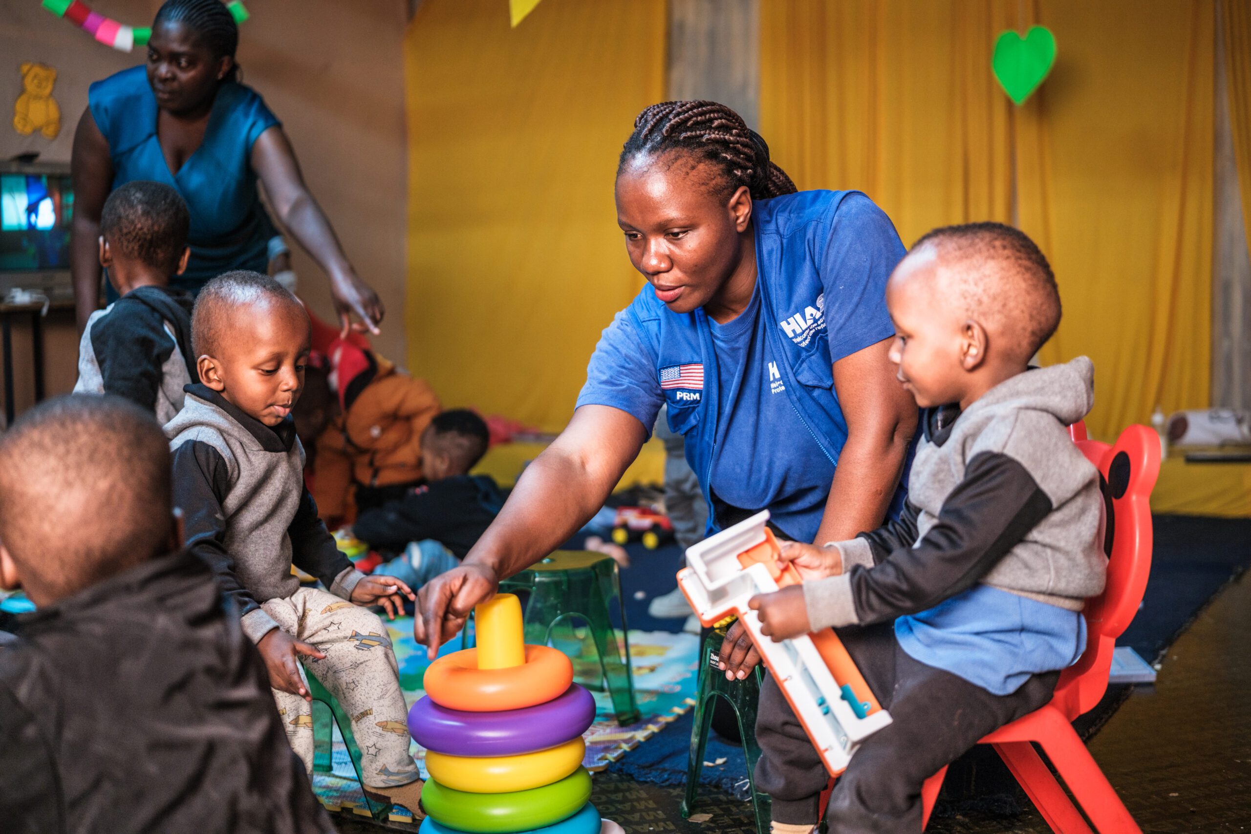 Gloria, a HIAS Kenya Child Protection Associate, interacts with refugee children in Nairobi in June 2026 (Brian Otieno for HIAS).