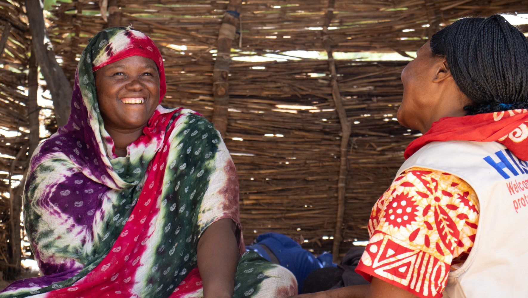 Matoua, a HIAS Chad program participant, speaks with Fatimé, a HIAS staff member, in Arkoum in June 2026 (Saam Kouakaine for HIAS).