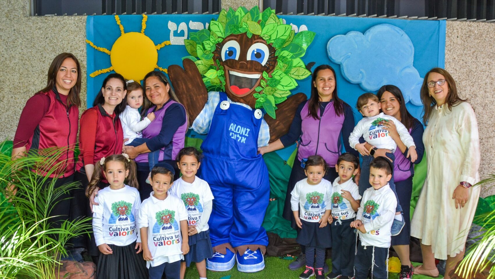 Students and teachers at a Jewish school in Venezuela pose with a costume produced by survivors of gender-based violence.