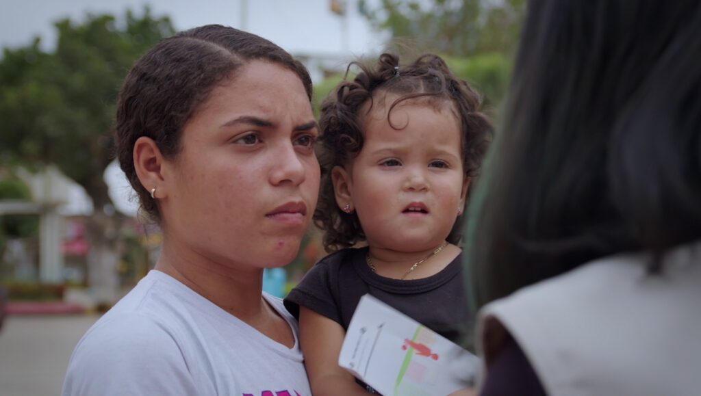 A HIAS staff member speaks with a woman and girl about HIAS' programs to address violence against women and girls. End Violence Against Women and Girls | HIAS