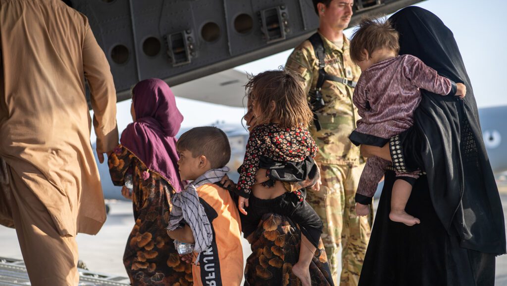 U.S. Air Force loadmasters and pilots help passengers board an aircraft during the evacuation of Afghanistan. | Afghan Asylum Seekers Struggle to Gain Legal Status in the U.S. | HIAS