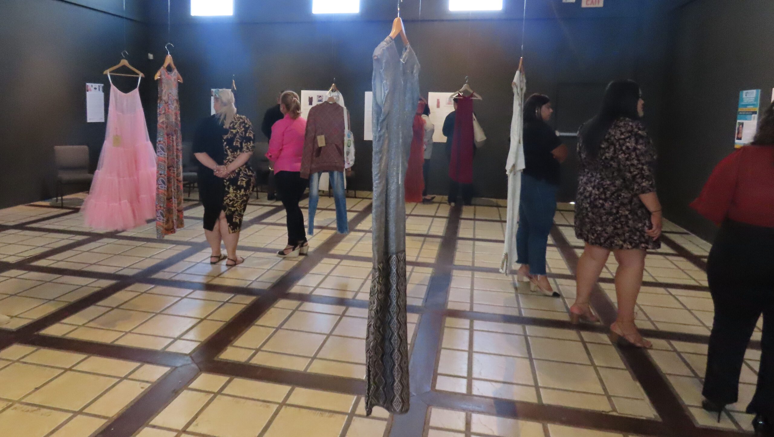 Art exhibition on GBV shows the original garments of murdered women. Among the clothing on display are an embroidered dress, a green T-shirt, a pair of jeans, a sleeveless linen top, and a denim jacket.