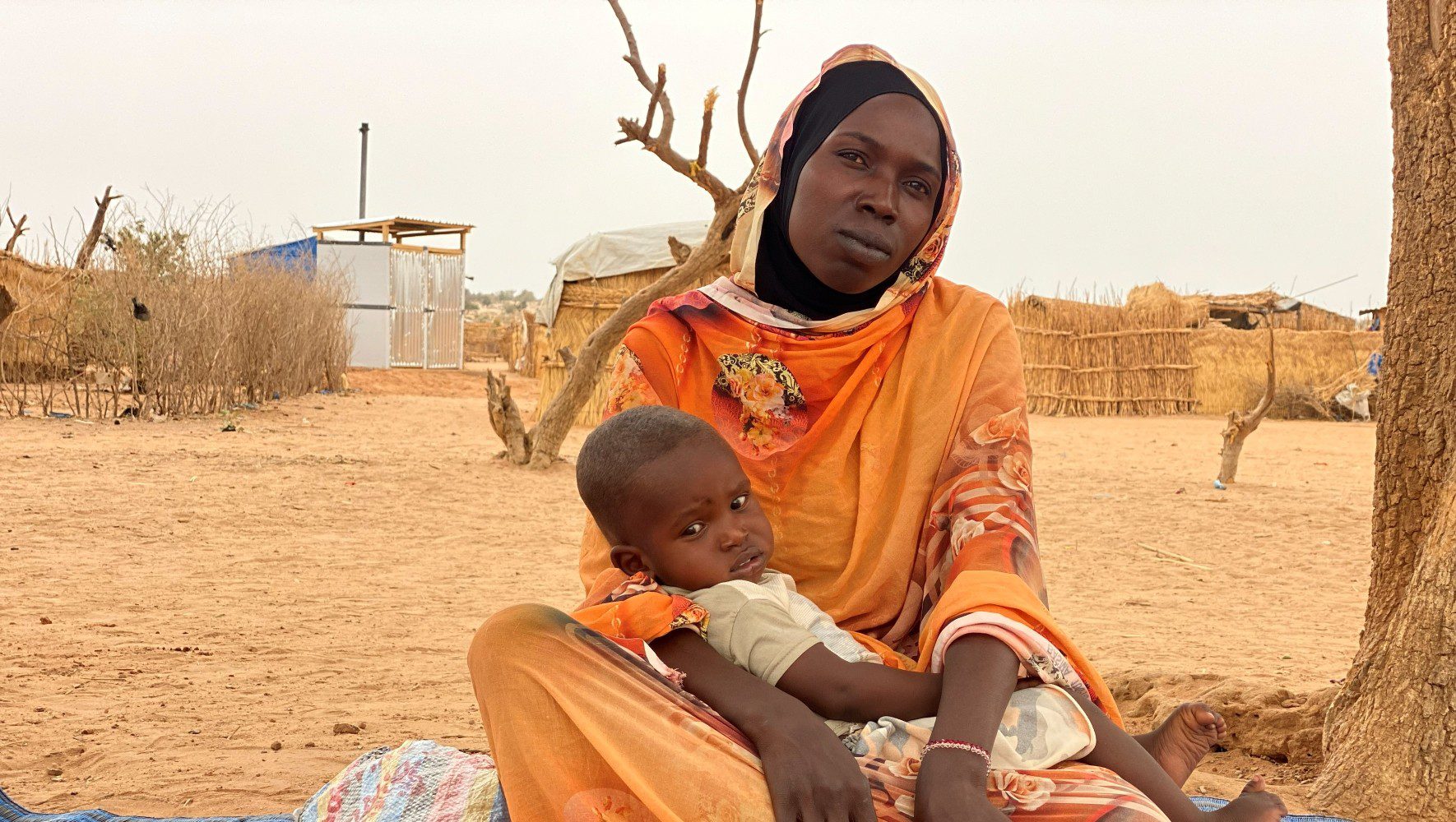 HIAS staff assist a Sudanese refugee and her son in the Camp d’Aboutengué refugee camp in Chad on June 10 2024. (Moundi Kouakaine/HIAS)