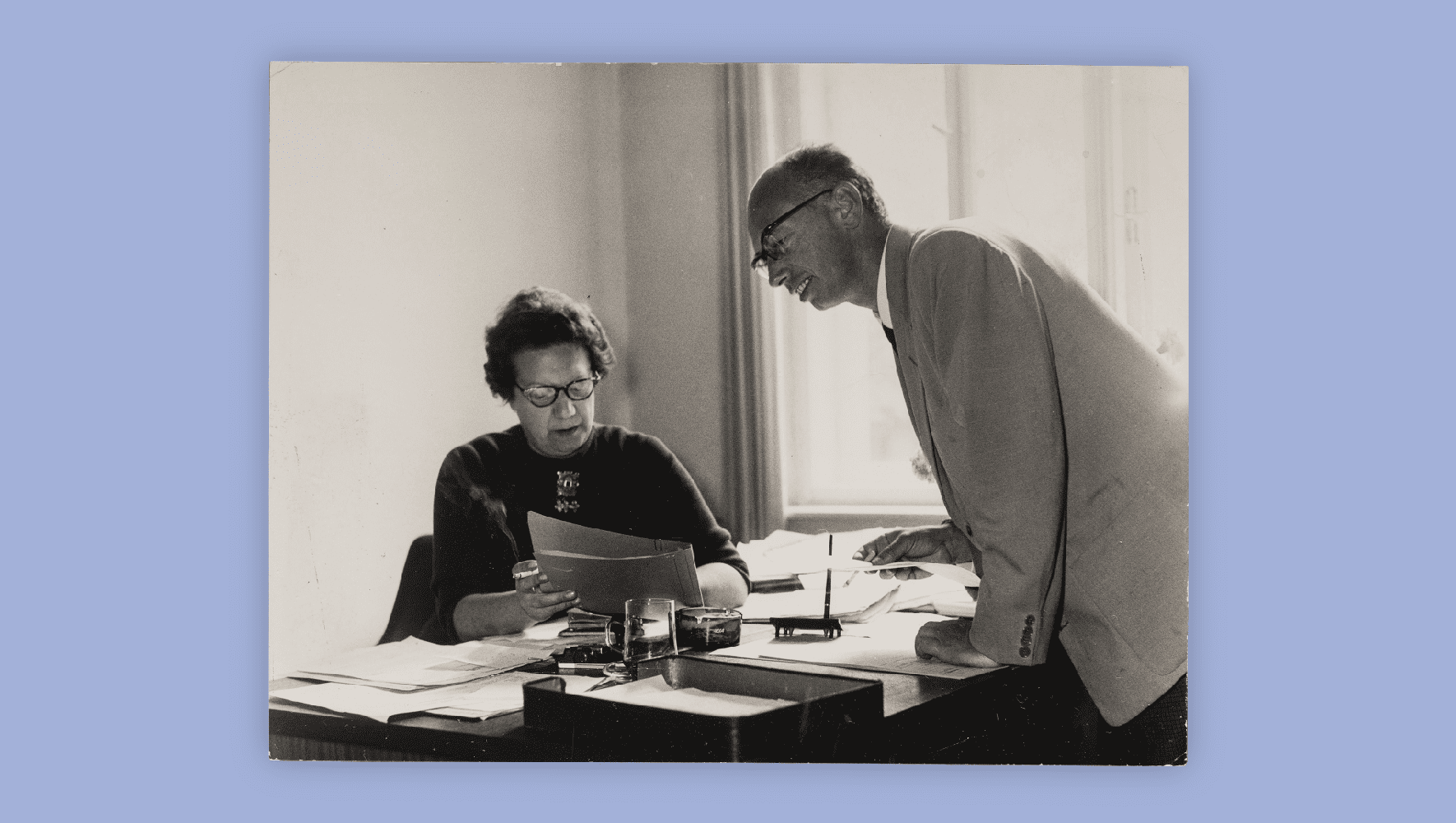 Director of the HIAS Vienna office (left) checks a case file with a Czech client who also filled in as receptionist and interpreter during his processing period. (HIAS)