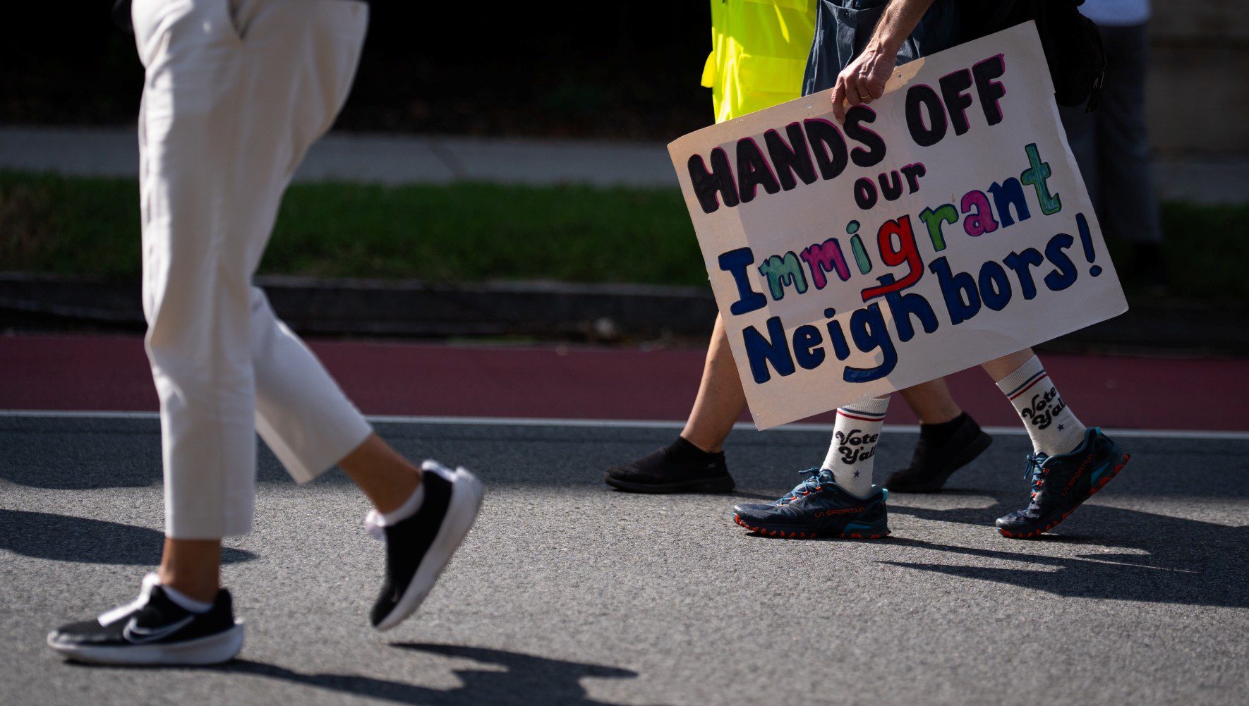 A person carries a protest sign in observance of the 111th World Day of Migrants and Refugees in Washington, D.C. on September 28, 2025 (Sarah L. Voisin/Getty Images).