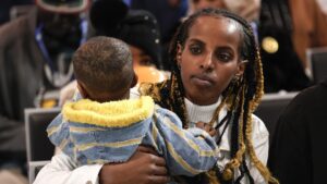 A refugee and her baby attend a welcome ceremony upon their arrival in Rome, Italy on March 05, 2024. 97 refugees were rescued from Libyan detention camps and will now be hosted across Italy. (Riccardo De Luca/Anadolu via Getty Images)