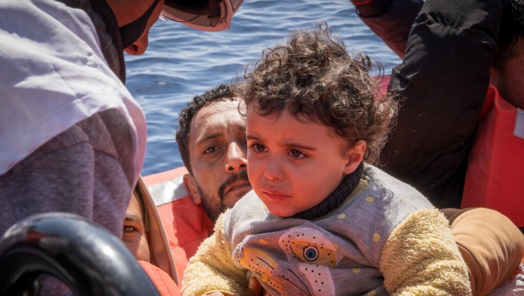 A child is rescued from a boat in the middle of the Mediterranean Sea on March 16, 2024. The Doctors Without Borders vessel rescued more than 170 people. Between 2,000 and 3,000 migrants and asylum seekers are estimated to die or go missing while crossing the Mediterranean Sea every year. (Simone Boccaccio/SOPA Images/LightRocket via Getty Images)