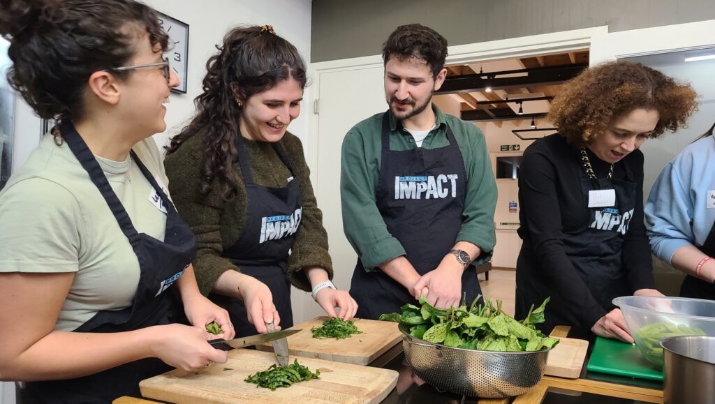 Refugee supporters join HIAS+JCORE and partner OLAM for a cooking event in honor of Refugee Shabbat in London on March 11, 2026. (Jennie van den Boogaard/HIAS)
