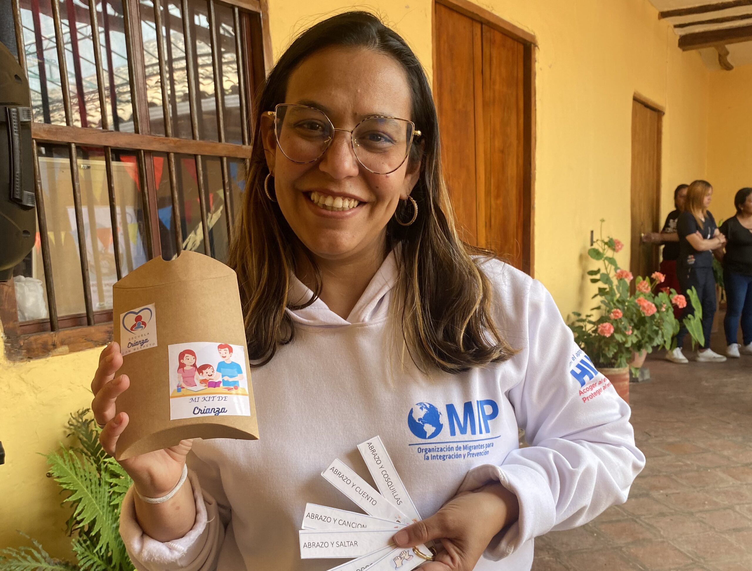 Corina, the legal representative of local partner organization OMIP, shows some of the items they use in workshops with parents and children. Pasto, Colombia, March 5, 2024. (Karolain Terán/HIAS Colombia)