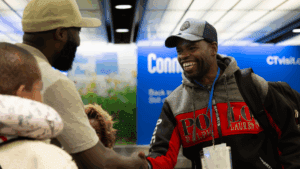 Staff from JFS of Western Massachusetts greet a refugee family at an airport.