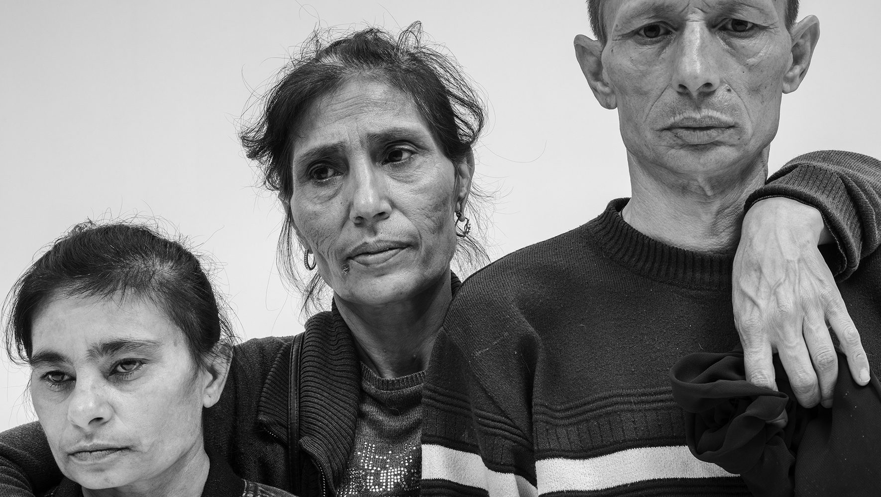 Three Roma refugees, black and white