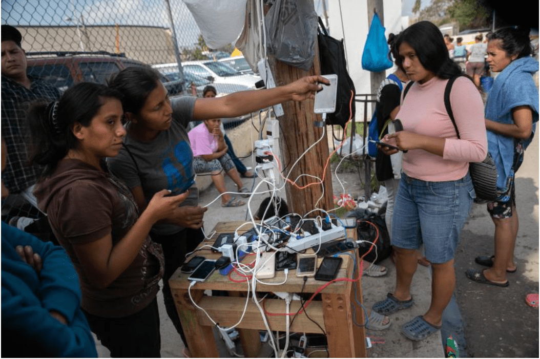 Asylum seekers charge their mobile phones at an immigrant camp in the border town of Matamoros, Mexico, on December 8, 2019.
(John Moore/Getty Images)