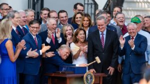 U.S. President Donald Trump, joined by Republican lawmakers, holds a gavel.