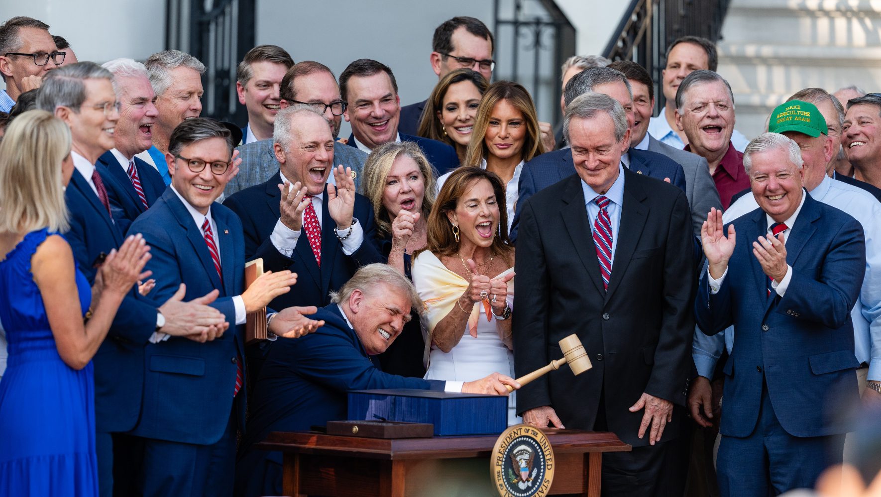 U.S. President Donald Trump, joined by Republican lawmakers, holds a gavel.
