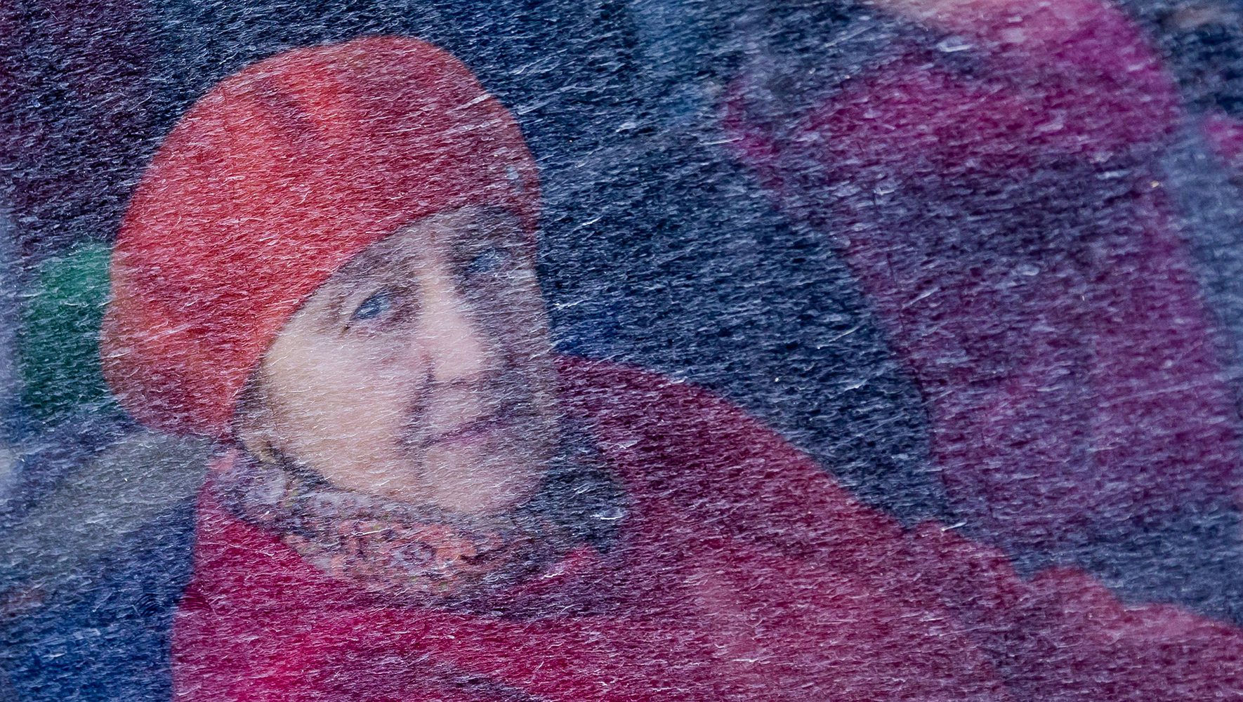 Behind a dirty window, a woman waits in a bus in Przemysl, Poland for the onward journey at the Medyka border crossing just over the Ukrainian border on the Polish side. | HIAS Center for Refugee Policy