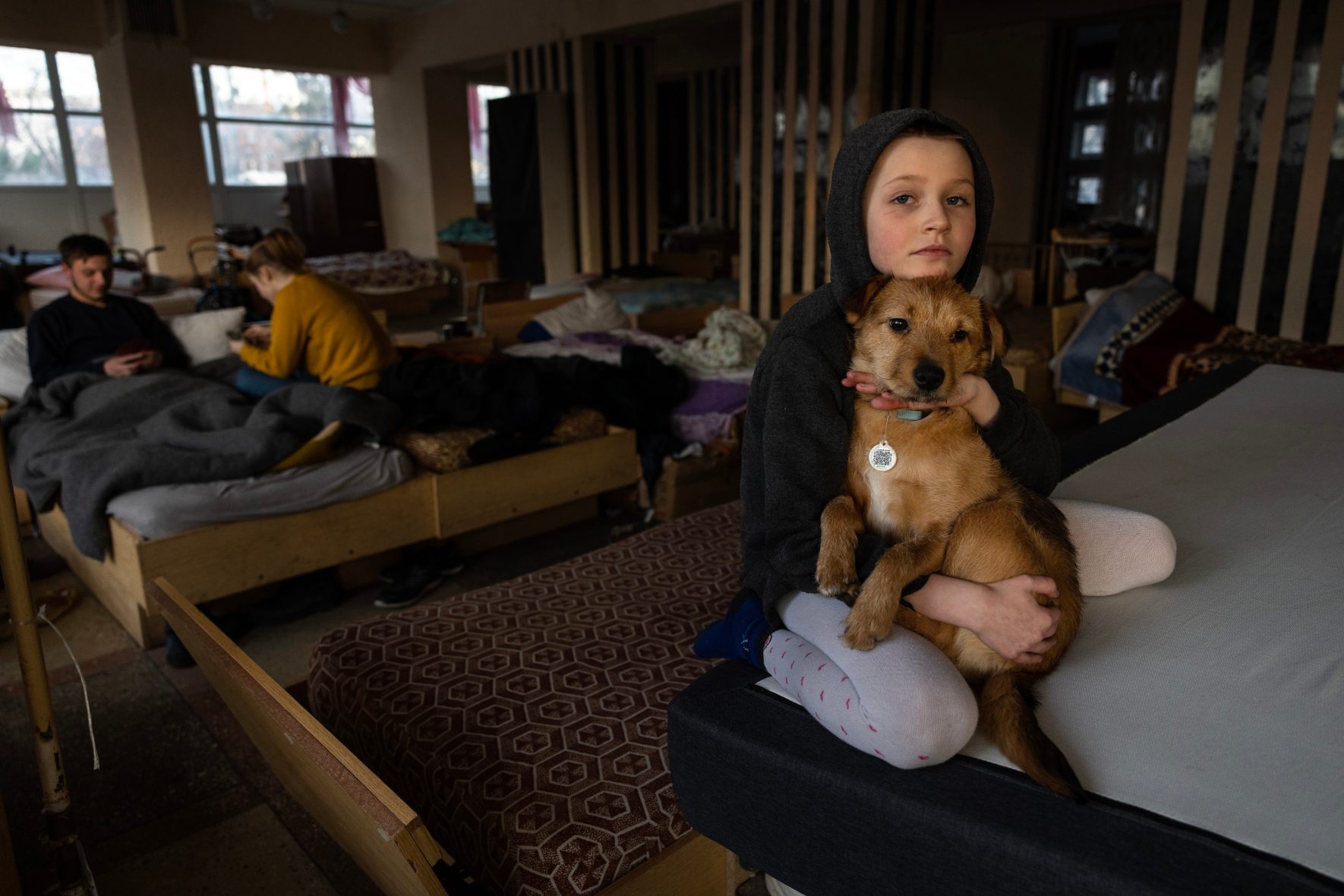 A girl and a dog reside at a shelter in Lviv, Ukraine.